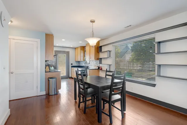 a dining room with furniture and window