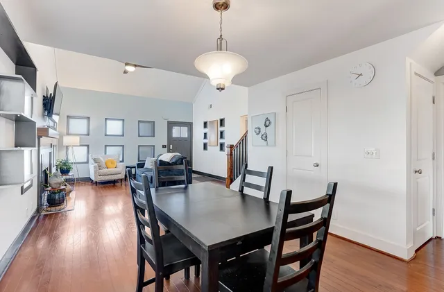 a view of a dining room with furniture and wooden floor