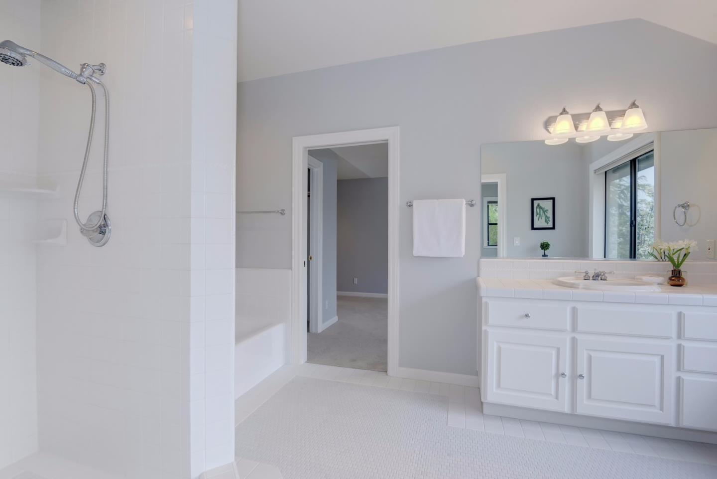6802 Graystone Lane San Jose, CA 95120 - Photo 32 of 38 a spacious bathroom with a double vanity sink a mirror and a shower