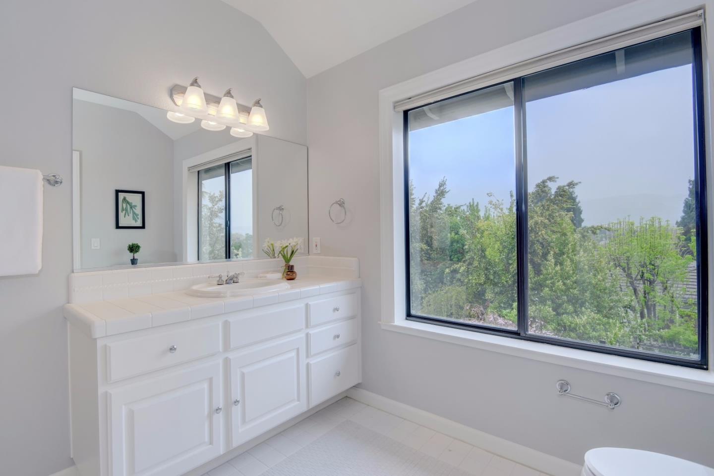 6802 Graystone Lane San Jose, CA 95120 - Photo 33 of 38 a spacious bathroom with a double vanity sink and a large mirror