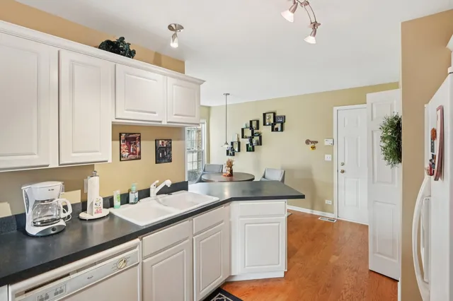 a spacious bathroom with stainless steel appliances a sink and a refrigerator