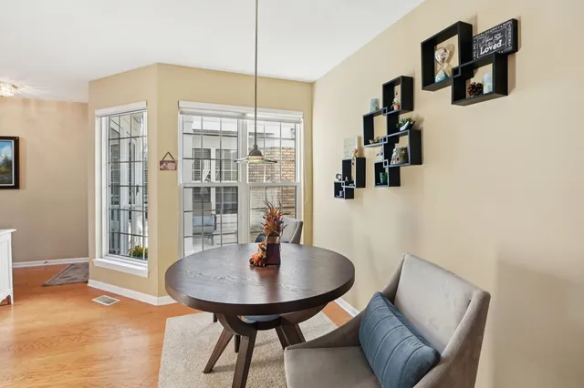 a view of a dining room with furniture and window