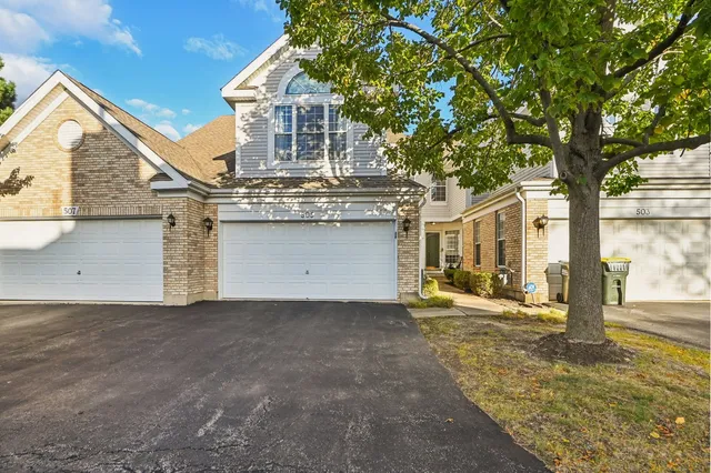 a view of a house with a tree in the background
