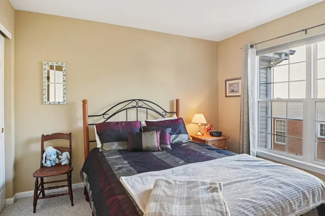 a bedroom with a bed a table and chair