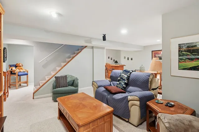 a living room with furniture and stairs