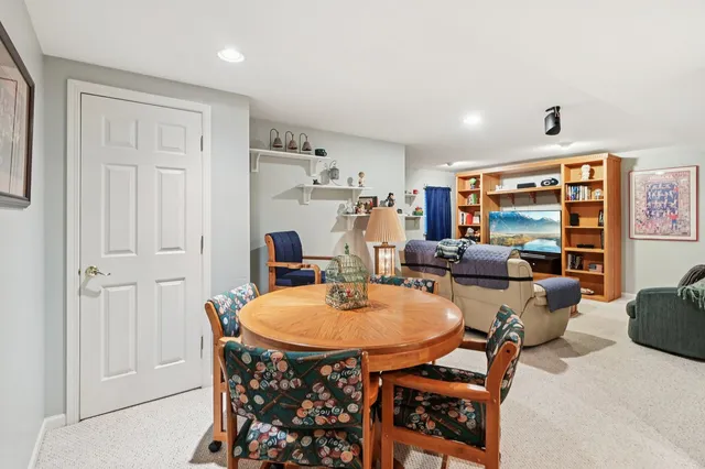 a dining room with furniture and a chandelier