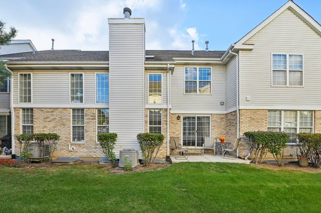 a front view of house with a garden and patio
