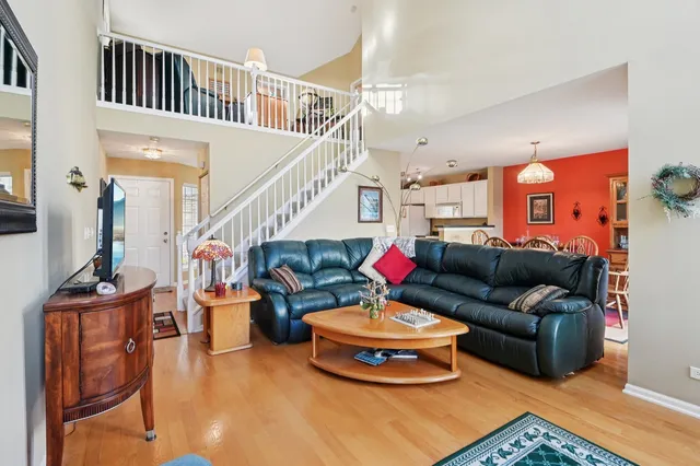 a living room with furniture and a chandelier