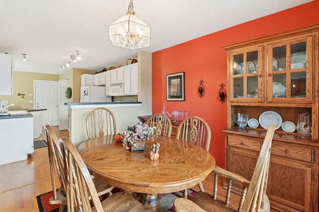 a dining room with furniture a chandelier and wooden floor