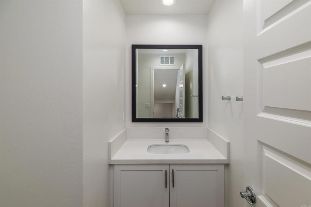 6140 Colt Place, Unit 104 Carlsbad, CA 92009 - Photo 13 of 37 a bathroom with a sink and a mirror