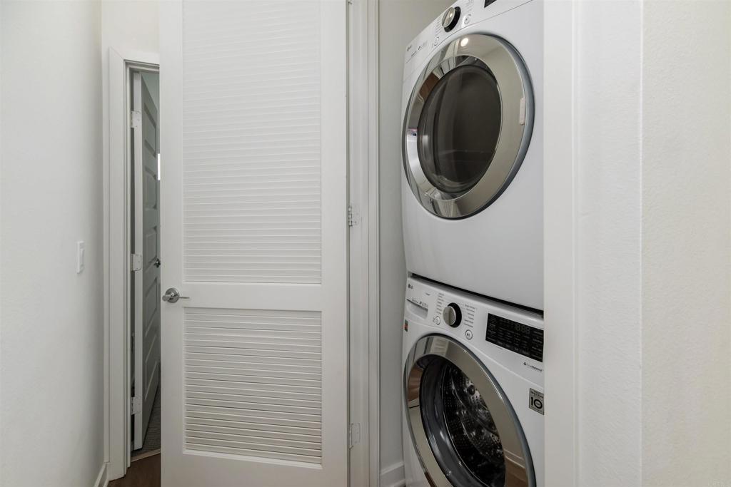 6140 Colt Place, Unit 104 Carlsbad, CA 92009 - Photo 15 of 37 a view of a storage and utility room with washer and dryer