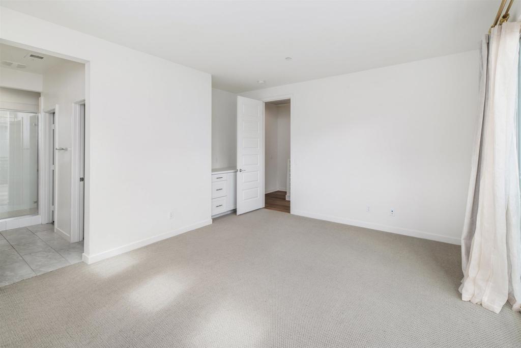 6140 Colt Place, Unit 104 Carlsbad, CA 92009 - Photo 17 of 37 an empty room with an entryway