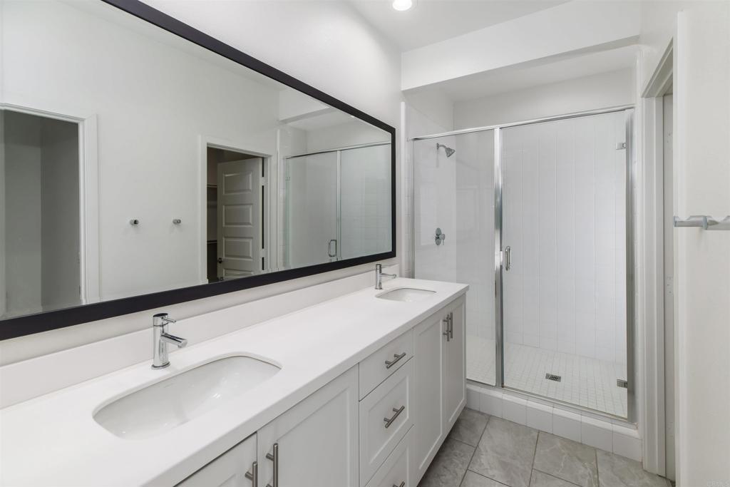 6140 Colt Place, Unit 104 Carlsbad, CA 92009 - Photo 18 of 37 a bathroom with a sink and a mirror