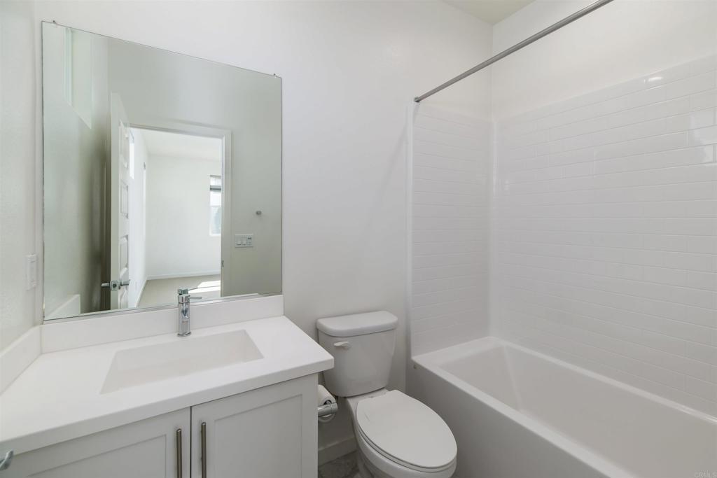 6140 Colt Place, Unit 104 Carlsbad, CA 92009 - Photo 21 of 37 a bathroom with a sink a toilet and shower