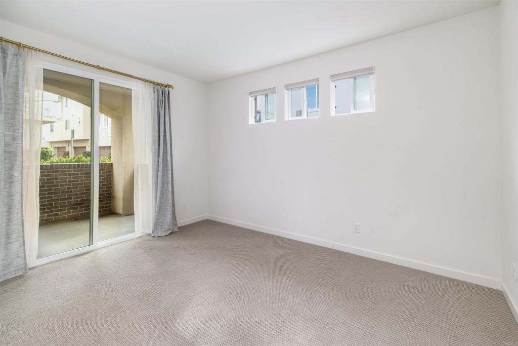 6140 Colt Place, Unit 104 Carlsbad, CA 92009 - Photo 22 of 37 an empty room with windows