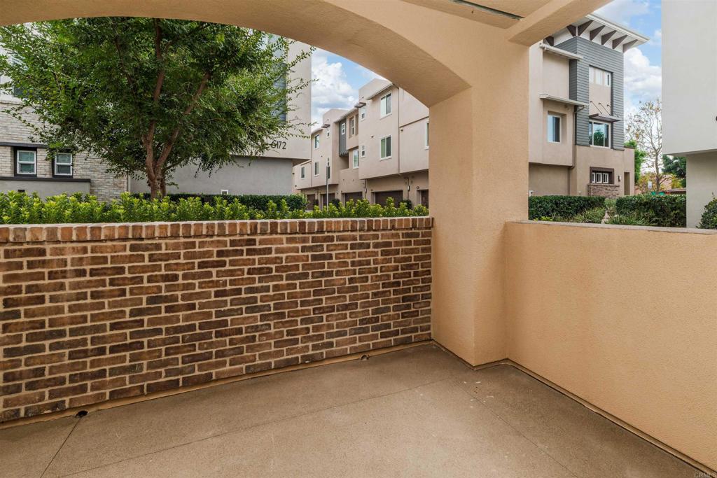 6140 Colt Place, Unit 104 Carlsbad, CA 92009 - Photo 23 of 37 a view of a brick wall of the building