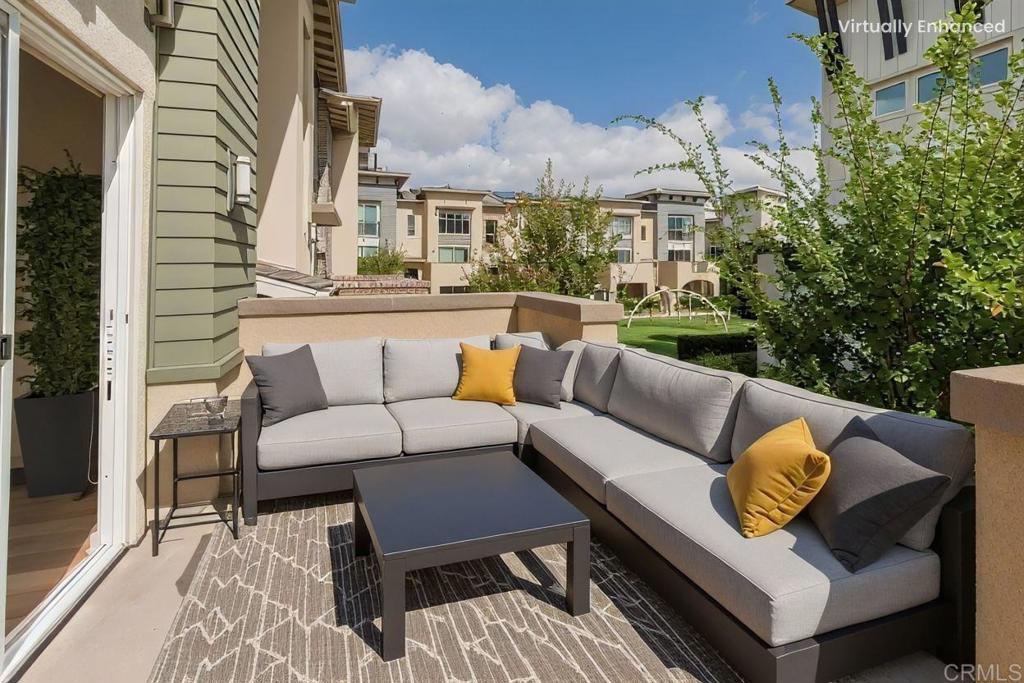 6140 Colt Place, Unit 104 Carlsbad, CA 92009 - Photo 25 of 37 a view of a patio with couches and a potted plant on a table