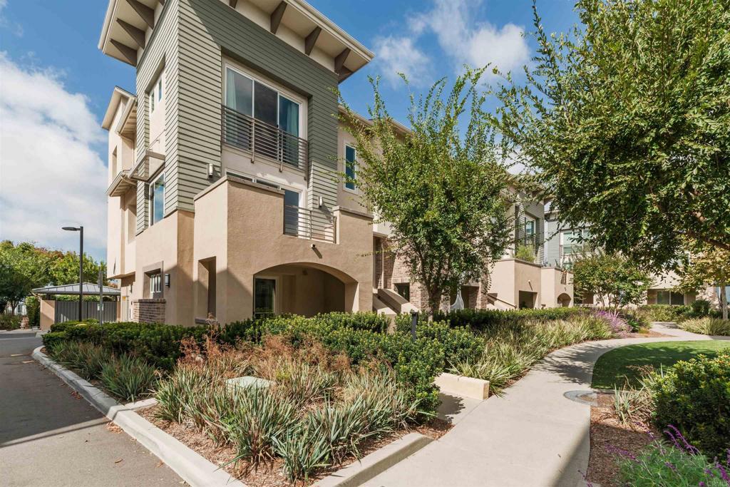 6140 Colt Place, Unit 104 Carlsbad, CA 92009 - Photo 29 of 37 a front view of a house with garden
