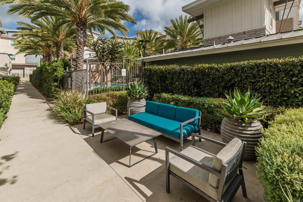 6140 Colt Place, Unit 104 Carlsbad, CA 92009 - Photo 31 of 37 a view of a backyard with plants and a patio