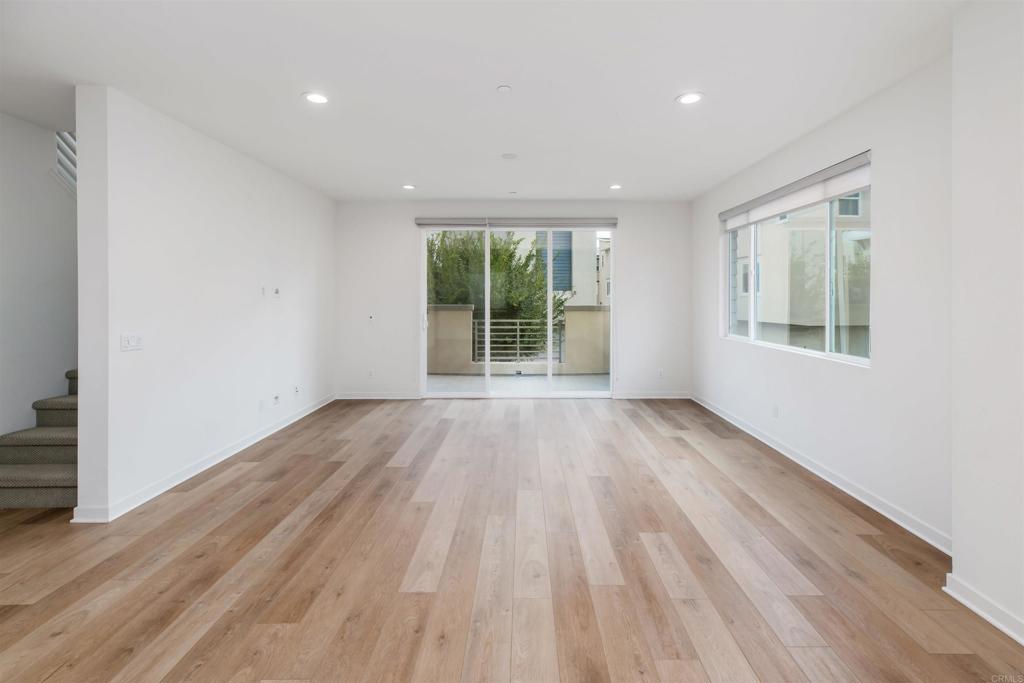 6140 Colt Place, Unit 104 Carlsbad, CA 92009 - Photo 8 of 37 a view of an empty room with wooden floor and a window