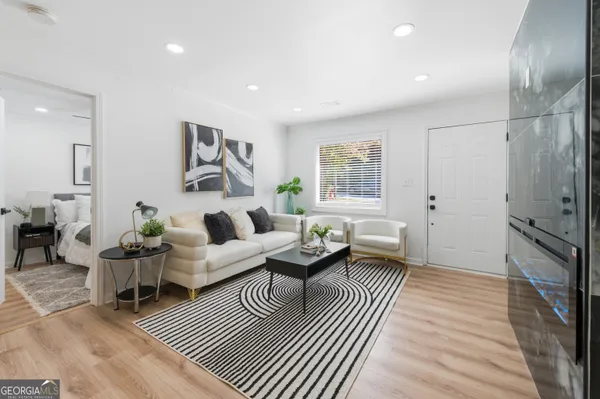 a living room with furniture a fireplace and a table