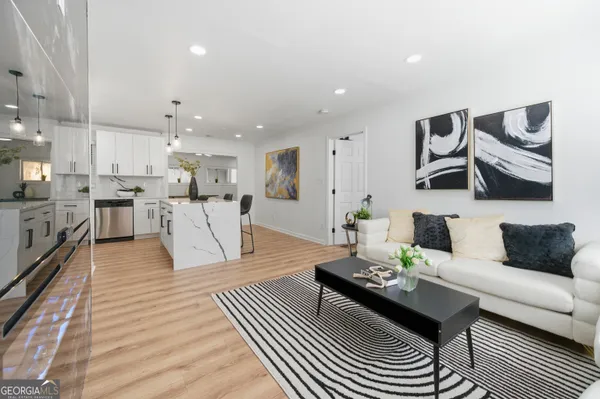 a living room with furniture and kitchen view