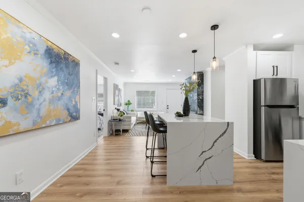 a large kitchen with a table and chairs