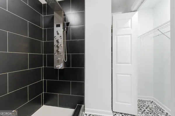 a bathroom with a toilet and a shower