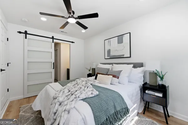 a bedroom with a bed and a potted plant