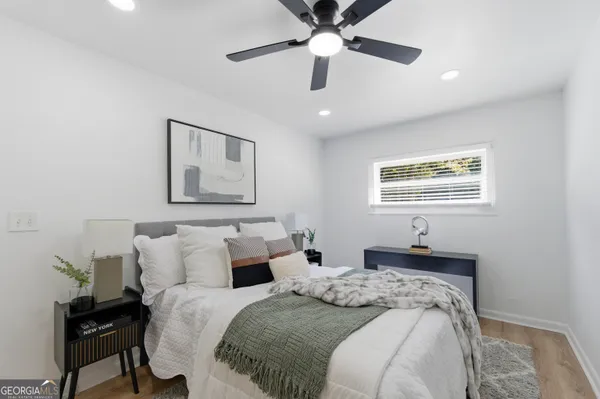 a bedroom with bed and a window