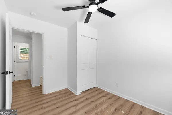a view of an empty room with wooden floor