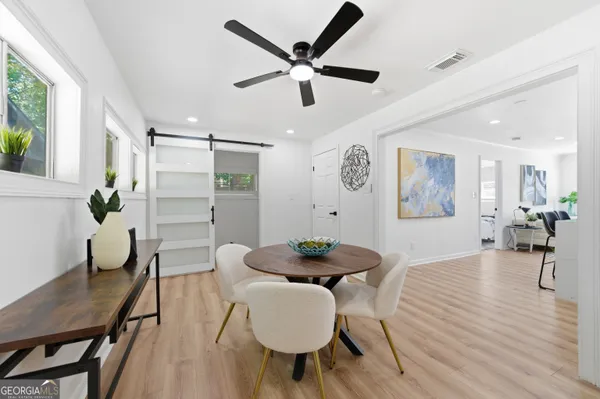 a dining room with furniture and wooden floor