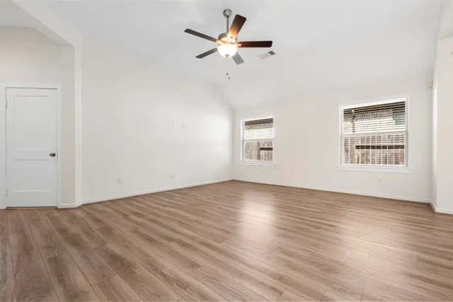 wooden floor in an empty room with a window