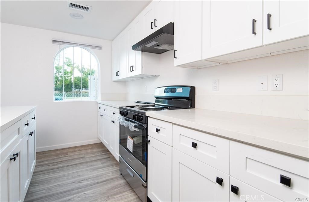5502 East Los Angeles Avenue, Unit 3 Simi Valley, CA 93063 - Photo 13 of 48 a kitchen with cabinets appliances a sink and a window