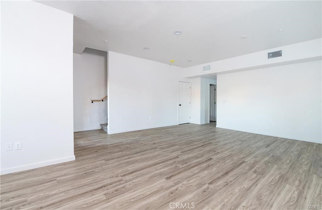5502 East Los Angeles Avenue, Unit 3 Simi Valley, CA 93063 - Photo 8 of 48 a view of an empty room with wooden floor