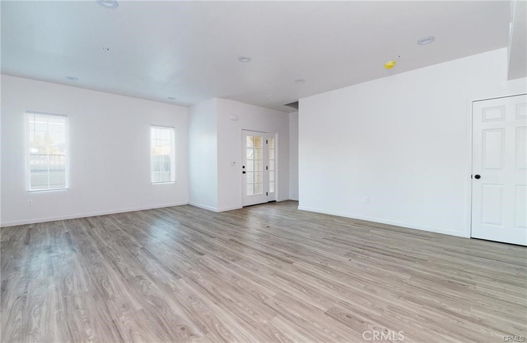 5502 East Los Angeles Avenue, Unit 3 Simi Valley, CA 93063 - Photo 9 of 48 an empty room with wooden floor