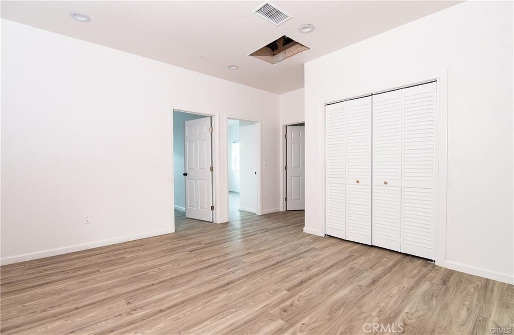 5502 East Los Angeles Avenue, Unit 3 Simi Valley, CA 93063 - Photo 10 of 48 a view of an empty room with wooden floor