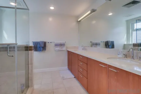 a bathroom with a granite countertop sink mirror and double