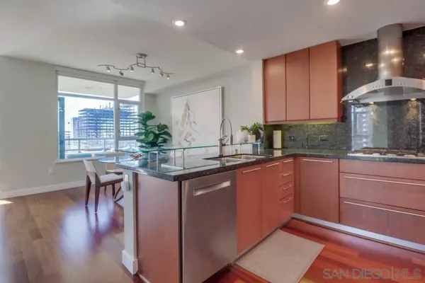 a kitchen with stainless steel appliances granite countertop a stove and a microwave
