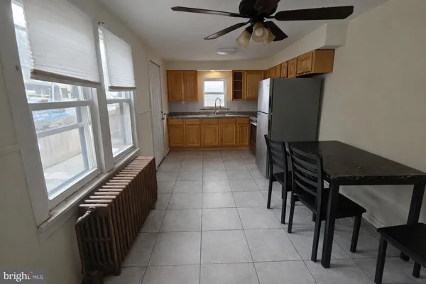 a kitchen with stainless steel appliances kitchen island granite countertop furniture and a refrigerator