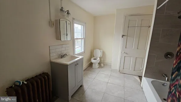 a bathroom with a sink toilet and mirror