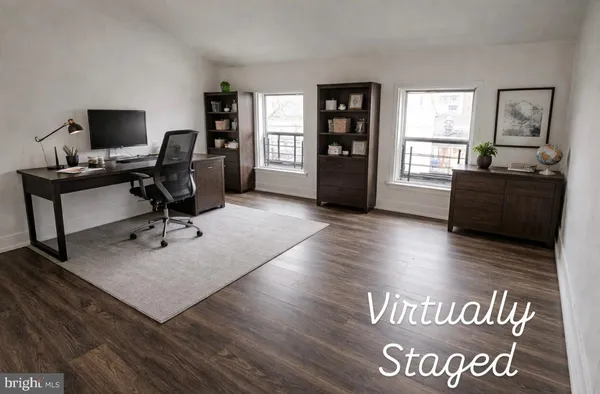 a view of a livingroom with workspace and a window