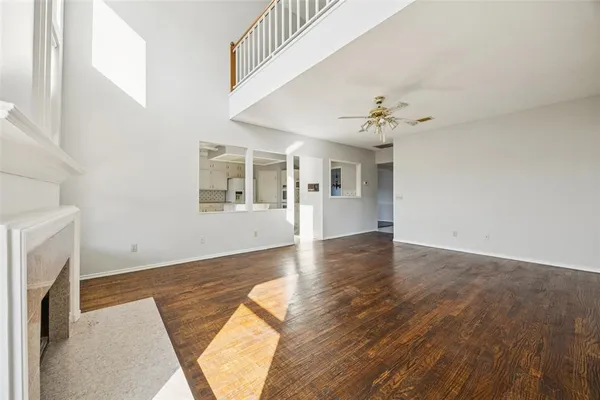 wooden floor in an empty room with a fireplace