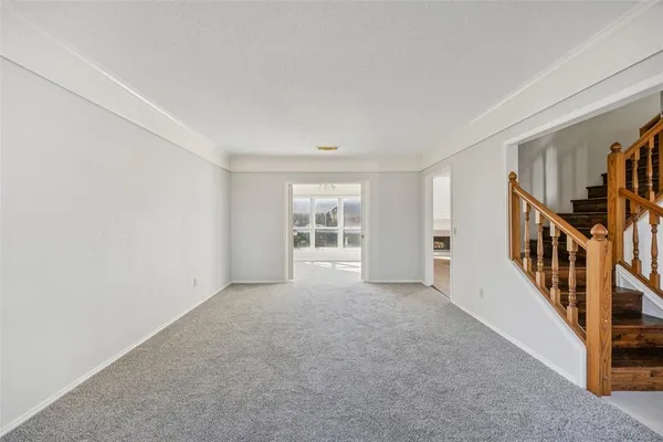 a view of an empty room with stairs