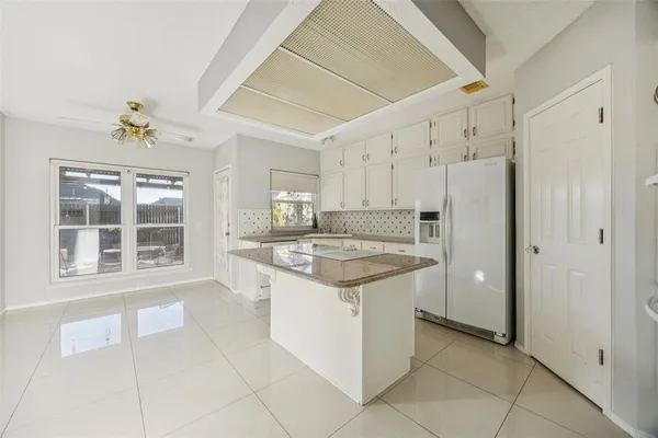 a kitchen with a stove a sink and a refrigerator
