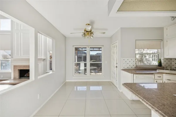 a view of an empty room with a fireplace and a window