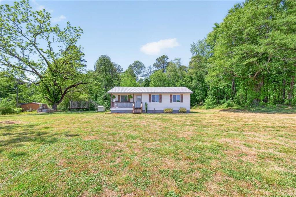 3696 Crabapple Hollow Road Nicholson, GA 30565 - Photo 29 of 38 a tall yellow house in middle of the forest