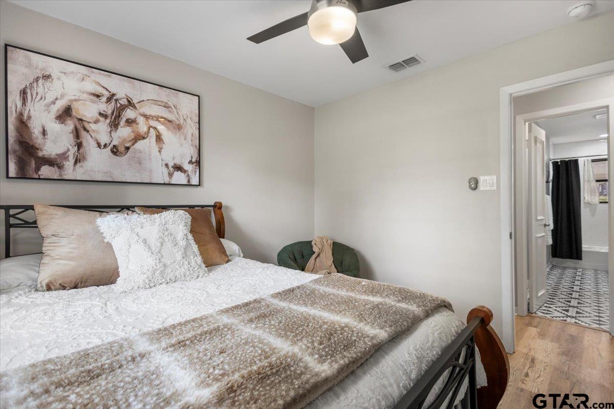 441 Hideaway Lane Hideaway, TX 75771 - Photo 14 of 38 a bedroom with a bed and a painting on the wall