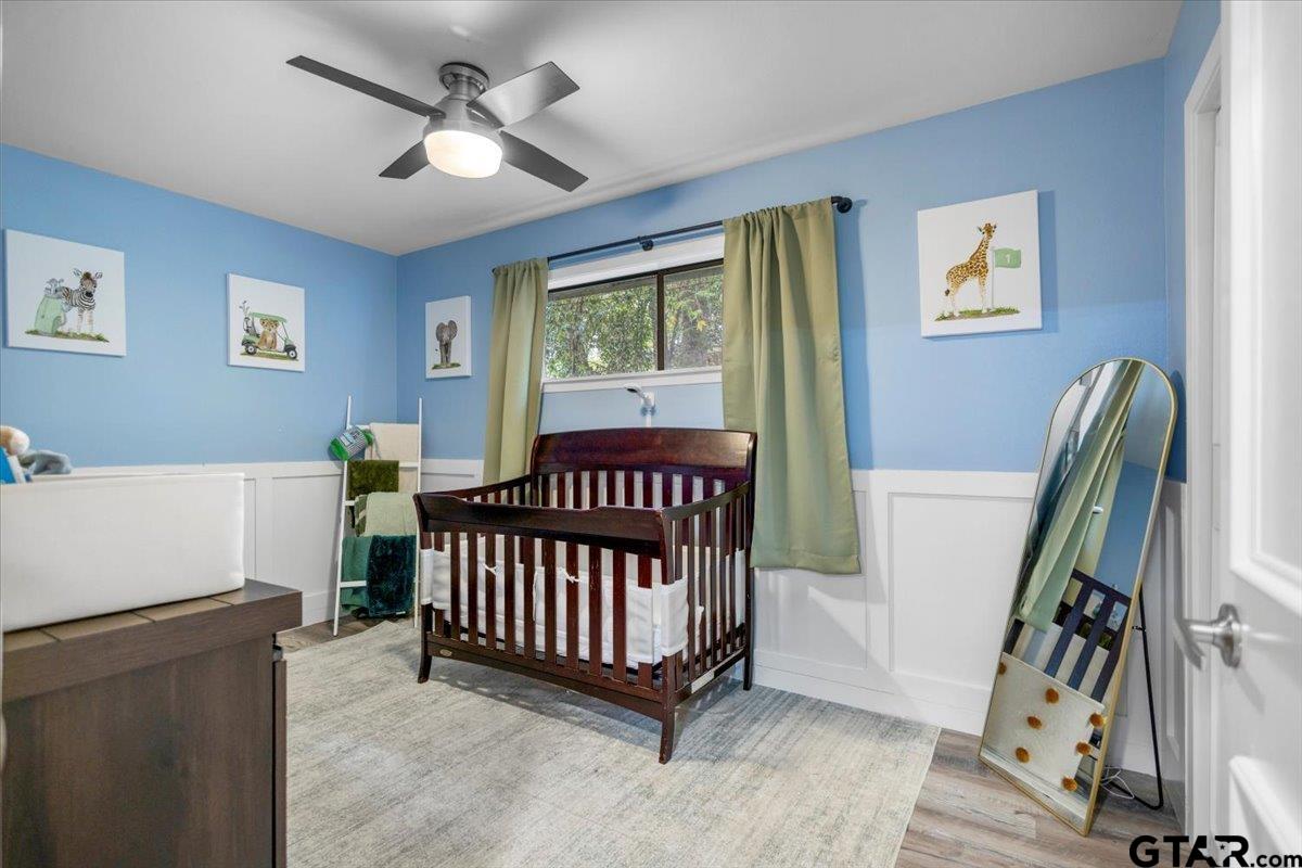 441 Hideaway Lane Hideaway, TX 75771 - Photo 21 of 38 a view of a bedroom with furniture window and wooden floor