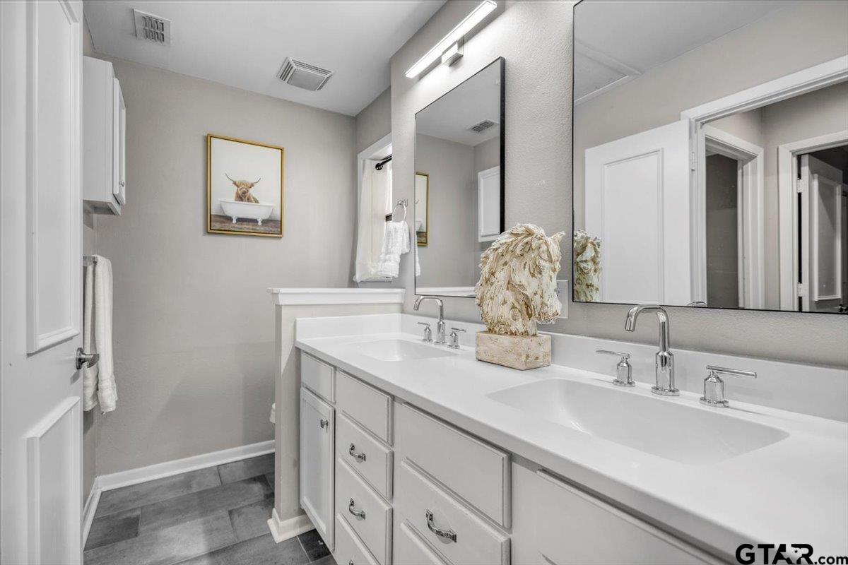 441 Hideaway Lane Hideaway, TX 75771 - Photo 22 of 38 a bathroom with a double vanity sink and a mirror